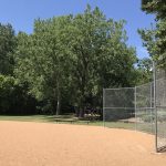 Tennis courts, a ball field, and huge green lawn are key features of Village Hall Park.